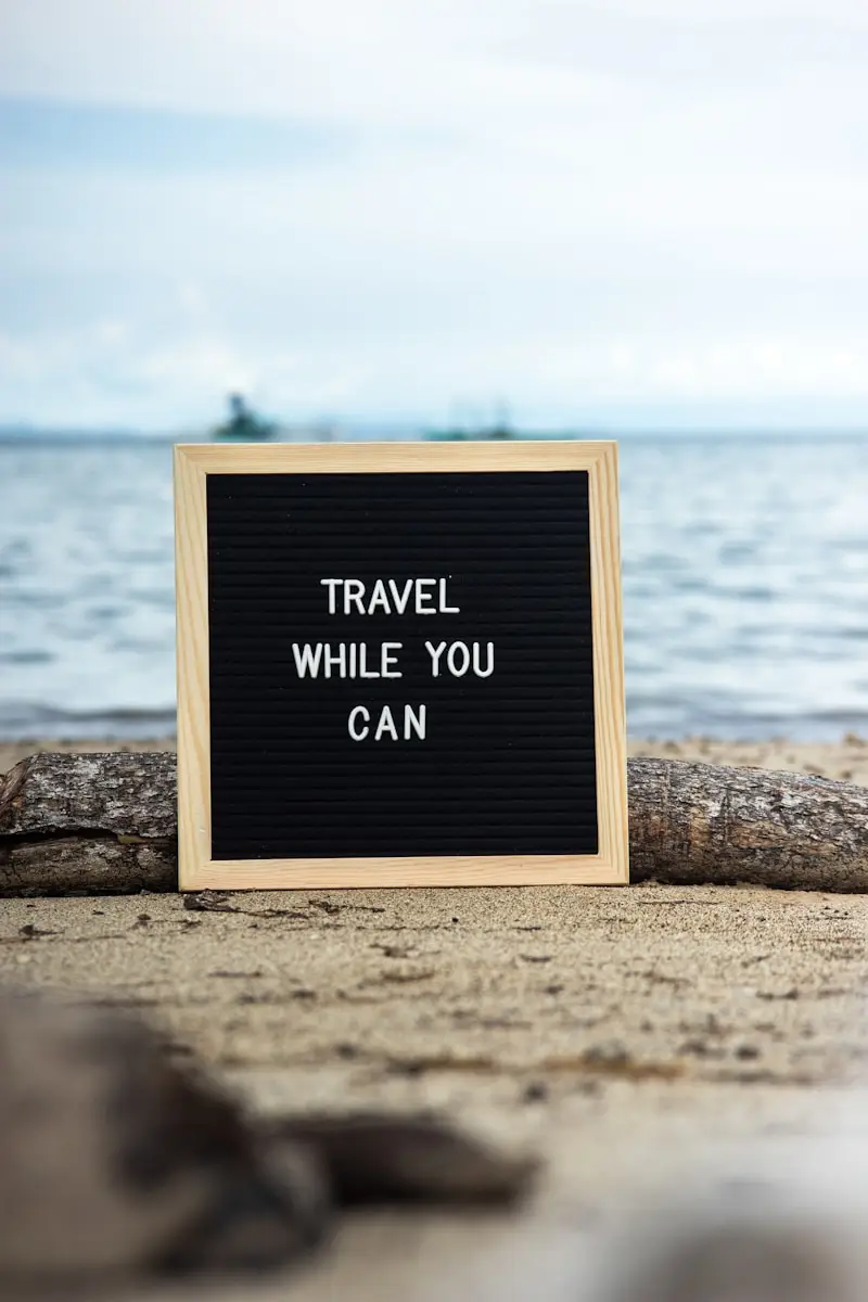 a sign that says travel while you can supporting travel insurance